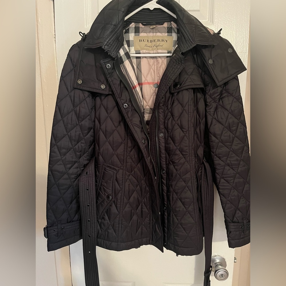 Burberry hooded jacket . Slightly worn , comes with plastic covers on zipper.